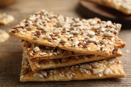 Stack of delicious crackers on table, closeup