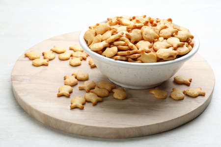 Delicious goldfish crackers in bowl on tableの写真素材