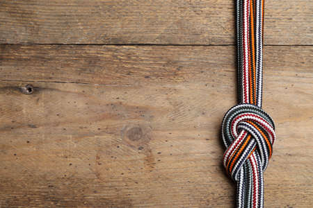 Top view of colorful ropes tied together on wooden background, space for text. unity conceptの写真素材