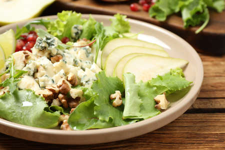 Fresh salad with pear on wooden tableの写真素材