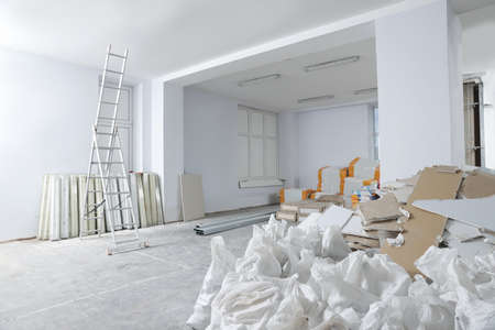 Used and new building materials in room prepared for renovationの写真素材