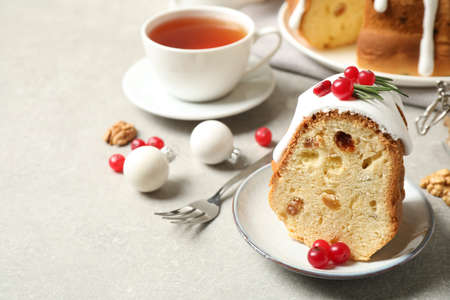 Composition with piece of traditional homemade Christmas cake on light gray table, closeup