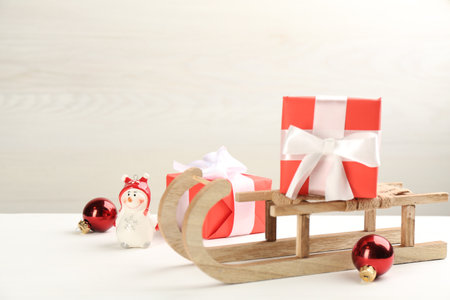 Beautiful Christmas composition with miniature sleigh on white table. Space for textの写真素材