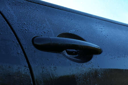 Wet car with door handle outdoors, closeup viewの写真素材