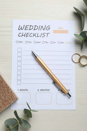 Flat lay composition with Wedding Checklist and planner on white wooden tableの写真素材
