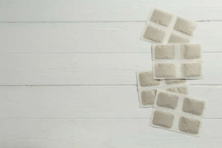 Mustard plasters on white wooden table, flat lay. Space for textの写真素材