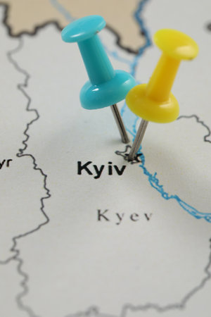 MYKOLAIV, UKRAINE - NOVEMBER 09, 2020: Kyiv city marked with push pins on contour map of Ukraine, closeupのeditorial素材