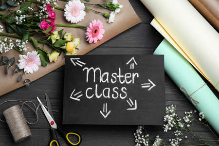 Card with words Master Class and supplies for flower arrangement on gray wooden table, flat layの写真素材