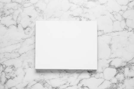 Blank canvas on white marble background, top view. space for designの写真素材