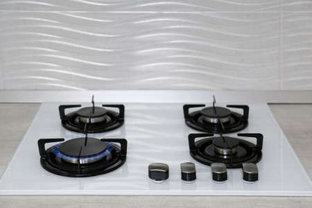 Modern kitchen stove with burning gas indoors