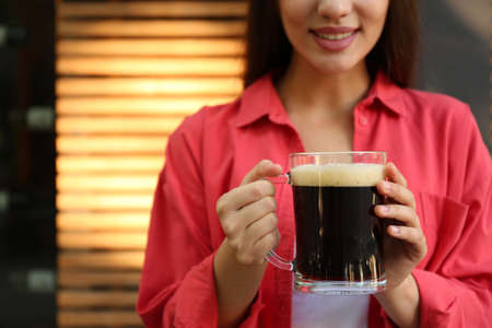 Young woman with cold kvass outdoors, closeup. Traditional Russian summer drinkの写真素材