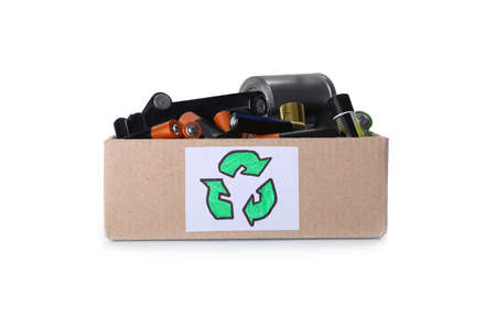 Used electric batteries in cardboard box with recycling symbol on white background
