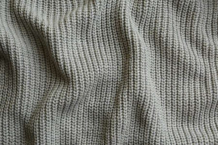 Beautiful gray knitted fabric as background, top view