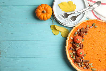Delicious homemade pumpkin pie on light blue wooden table, flat lay. Space for textの写真素材