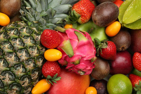 Assortment of fresh exotic fruits as background, top viewの写真素材
