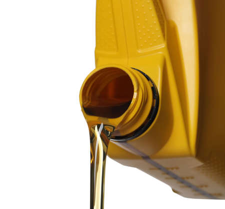 Man pouring motor oil from yellow container on white background, closeupの写真素材