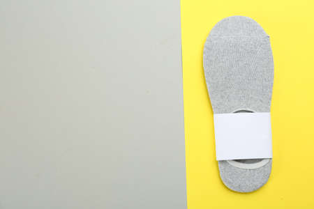 Pair of cotton socks on color background, top view. Space for textの写真素材