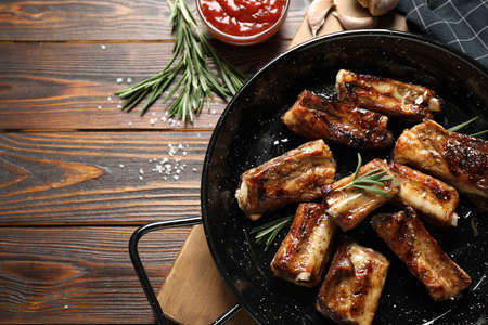 Delicious grilled ribs served on wooden table, flat layの写真素材