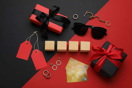 Blank wooden cubes, gift boxes, credit cards and fashionable accessories on color background, flat layの写真素材