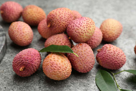 Fresh ripe lychee fruits on gray table, closeupの写真素材