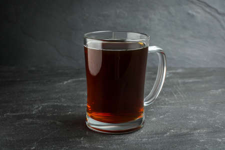 Mug of delicious kvass in mug on black tableの写真素材