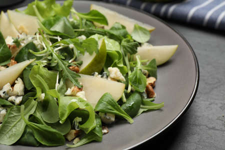 Tasty salad with pear slices on table, closeupの写真素材
