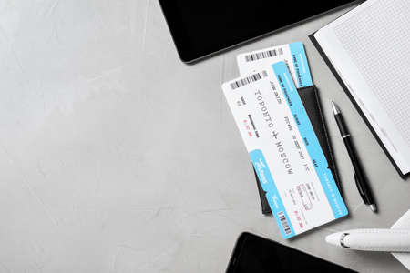 Flat lay composition with tickets on gray table, space for text. travel agency conceptの写真素材