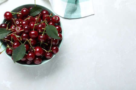 Sweet juicy cherries on light marble table, top view. Space for textの写真素材