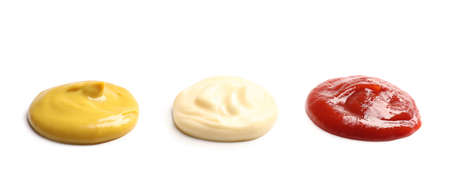 Tasty mustard, ketchup and mayonnaise isolated on whiteの写真素材
