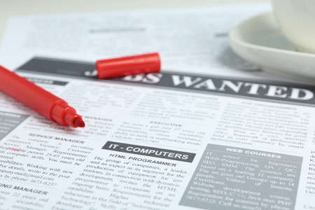 Red marker on newspaper near cup. Search conceptの写真素材