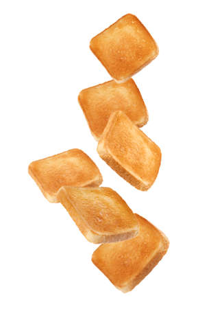 Slices of tasty toasted bread falling on white backgroundの写真素材