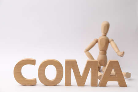 Word Coma made of wooden letters and human mannequin on light background, closeupの写真素材