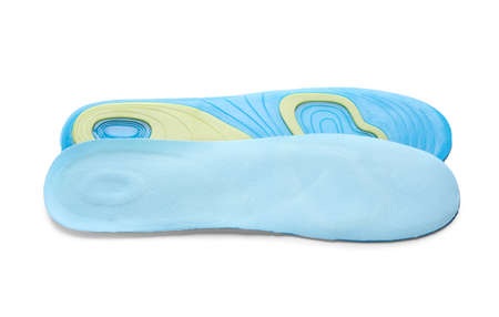 Light blue orthopedic insoles isolated on white