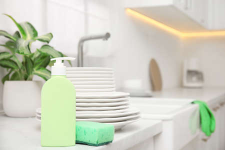 Clean dishes and cleaning products in stylish kitchen