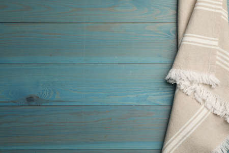Striped kitchen towel on light blue wooden table, top view. Space for textの写真素材