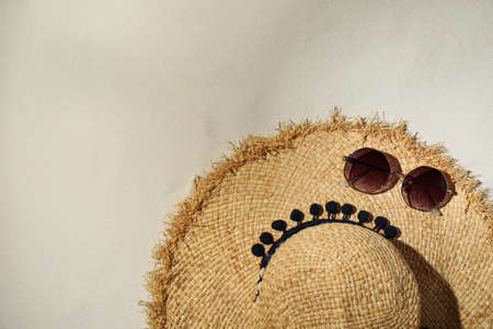 Flat lay composition with hat and sunglasses on sand. beach objects