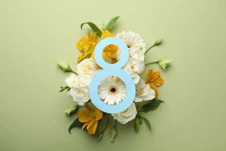 8 March greeting card design with beautiful flowers on green background, flat lay. International...