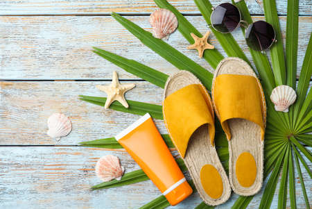 Beach objects on wooden background, flat lay
