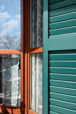 Window with vintage wooden shutters outdoors, closeup