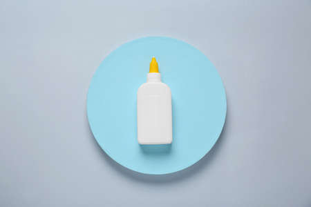 Bottle of glue on color background, top viewの写真素材
