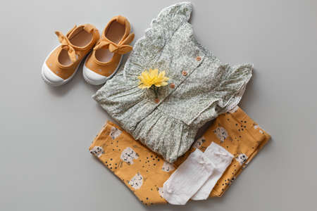 Stylish child clothes and shoes on gray background, flat layの写真素材