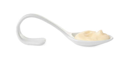 Mayonnaise in ceramic serving spoon isolated on whiteの写真素材