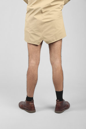 Exhibitionist in coat on light background, closeupの写真素材