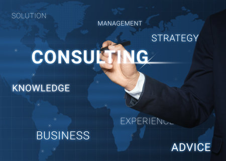 Man pointing at word CONSULTING on virtual screen, closeupの写真素材