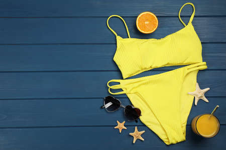 Flat lay composition with beach objects on blue wooden background, space for textの写真素材