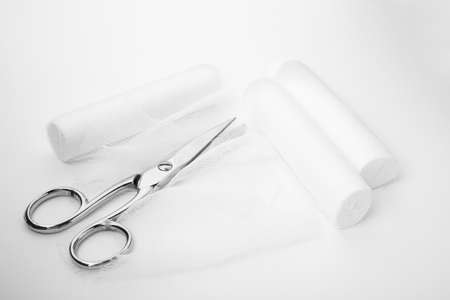 Medical bandage rolls and scissors on white backgroundの写真素材