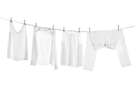 Different clothes drying on laundry line against white backgroundの写真素材