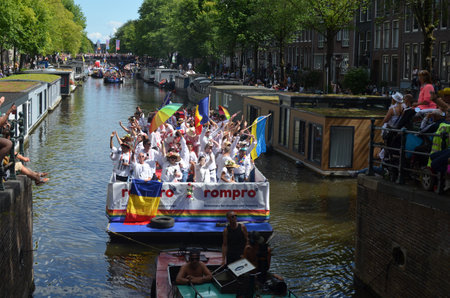 AMSTERDAM, NETHERLANDS - AUGUST 06, 2022: Many people in boats at LGBT pride parade on riverのeditorial素材