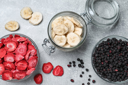 Many different freeze dried fruits on light gray table, flat layの写真素材