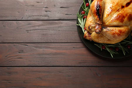 Delicious cooked turkey served on wooden table, top view with space for text. thanksgiving day celebrationの写真素材
